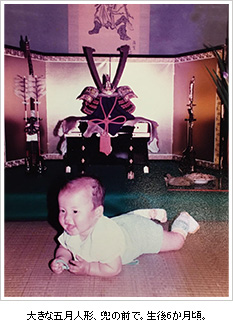 大きな五月人形、兜の前で。生後6か月頃。